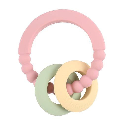 Pink, green, and yellow baby teething ring on a white background