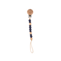 Beaded pacifier clip with wooden accents on a white background
