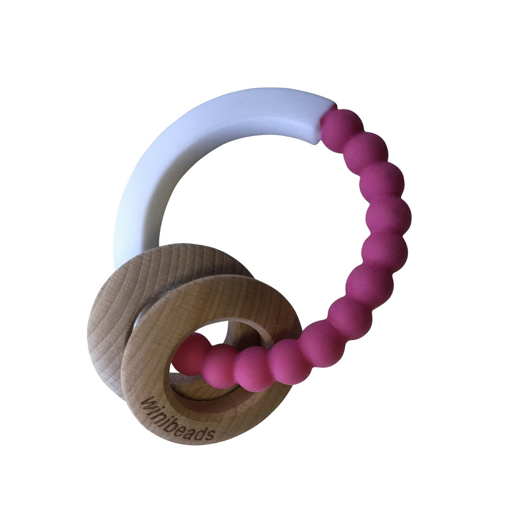 Teething ring with wooden and silicone components on a white background